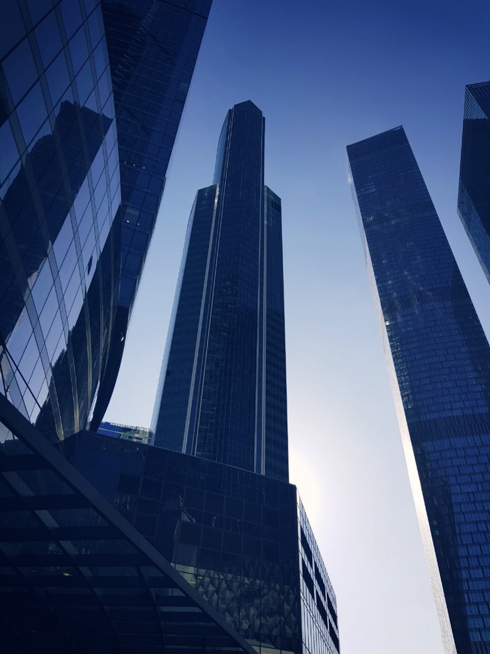 blue glass paneled buildings under clear blue sky